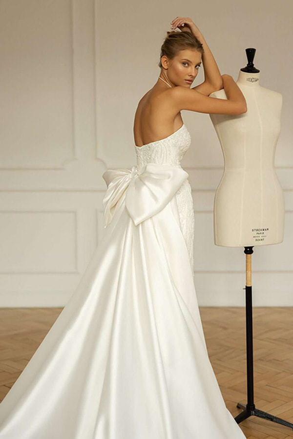 On trend overskirt and bows bridal dress.
